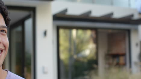 outside modern home, smiling man enjoying outdoors, copy space