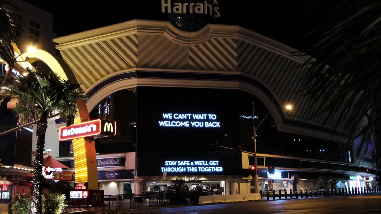 Empty Las Vegas Strip at Night and Closed Harrah's Hotel - Casino With Supporting Message During Coronavirus Lockdown
