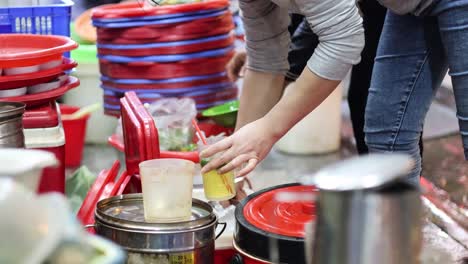 vendor skillfully prepares beverages in a bustling market