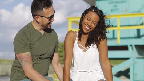 laughing stylish couple on seafront