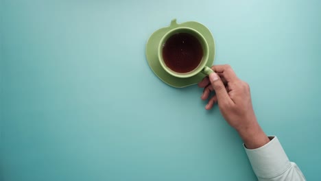 hand holding a cup of tea