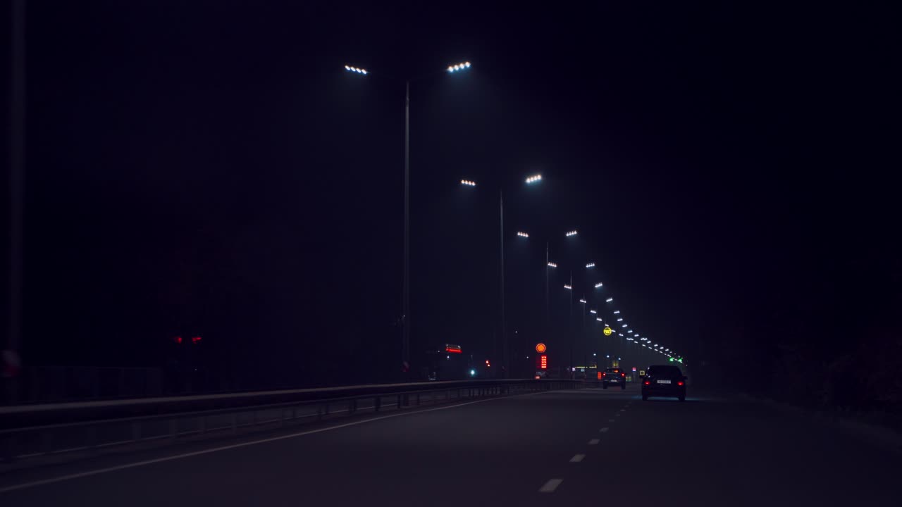 driving on the night highway. Cars are driving on the way to home in the evening