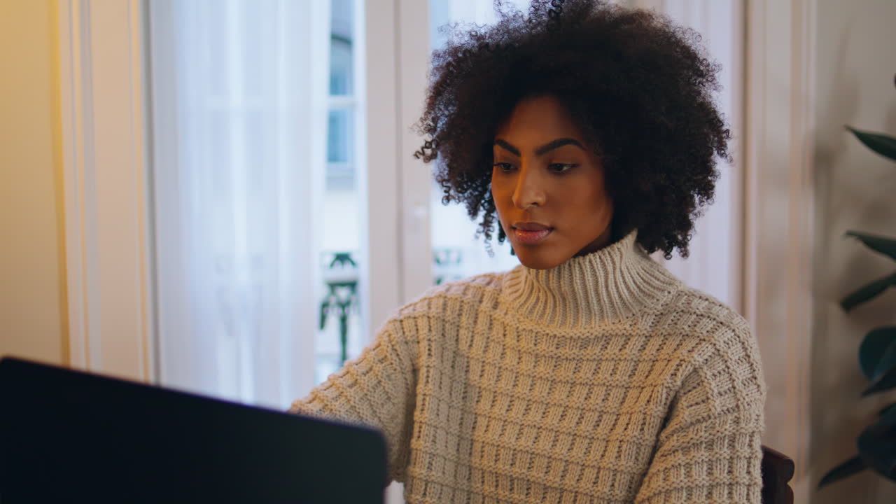 Calm model typing laptop home office closeup. Curly hair woman using computer
