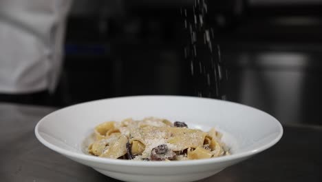 chef preparing creamy mushroom pasta