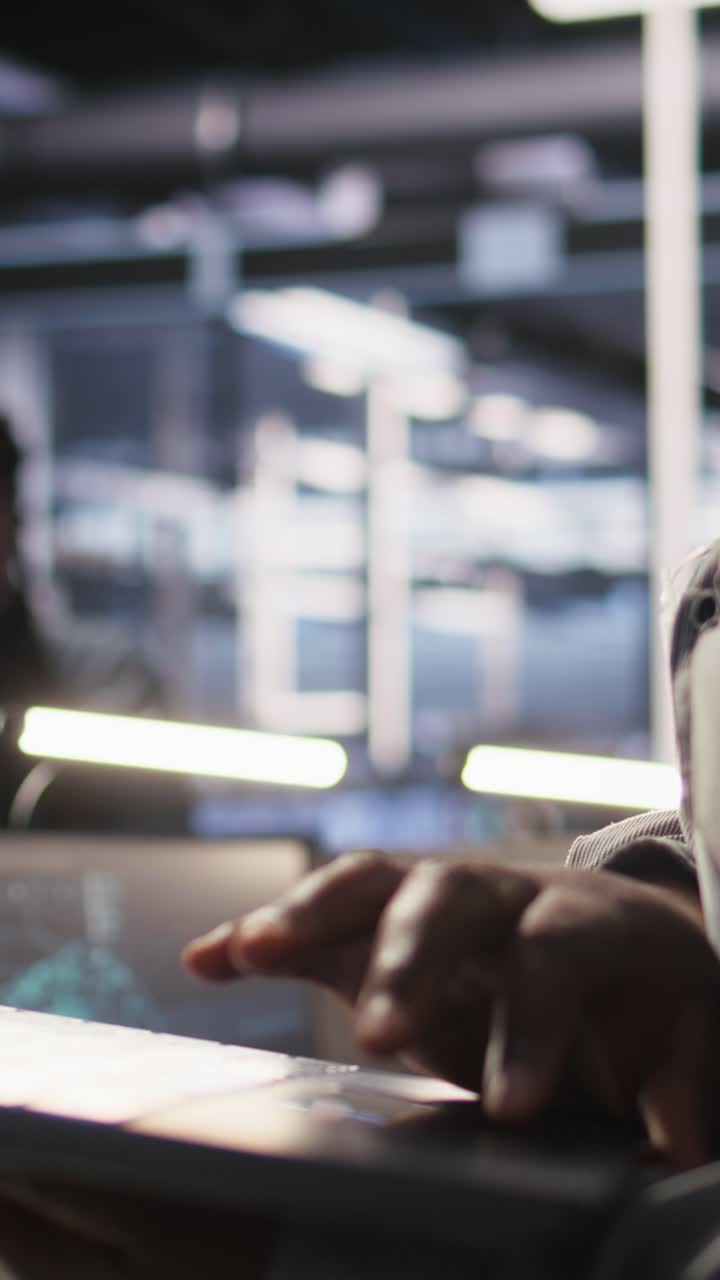 Vertical video Close up of data center engineer using laptop to monitor AI LLM visualization