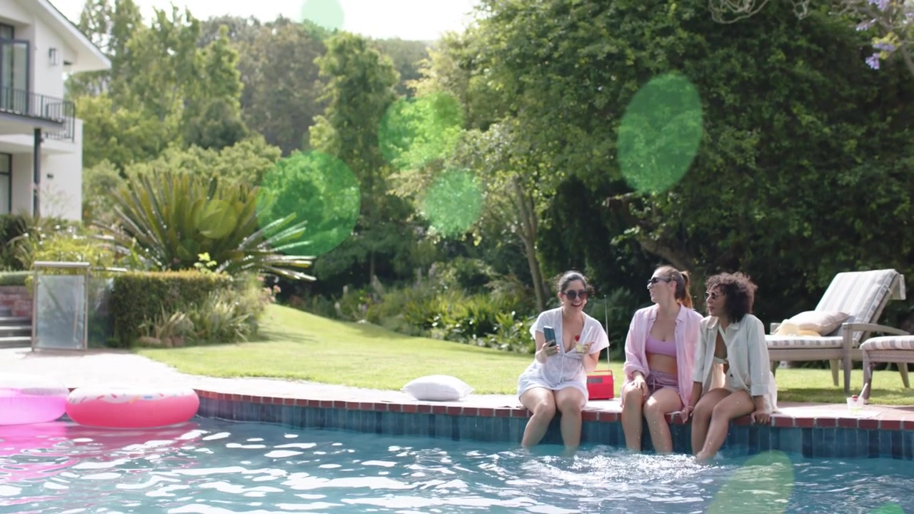 Three women showing smartphone screen by pool, sparking chat and splashing for content marketing