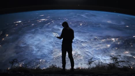 person with laptop looking at earth from space