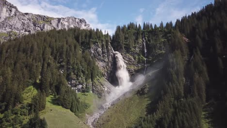 big waterfall with mountains high drone flight up stäubifall bei äsch kanton uri switzerland 4k