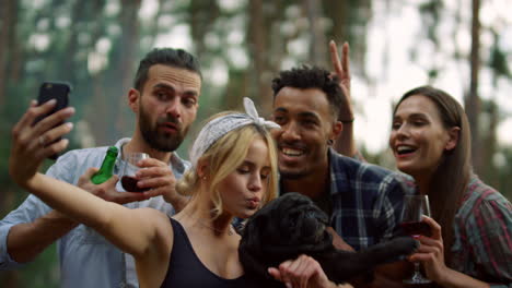 happy people making group photo in forest. cheerful friends posing camera