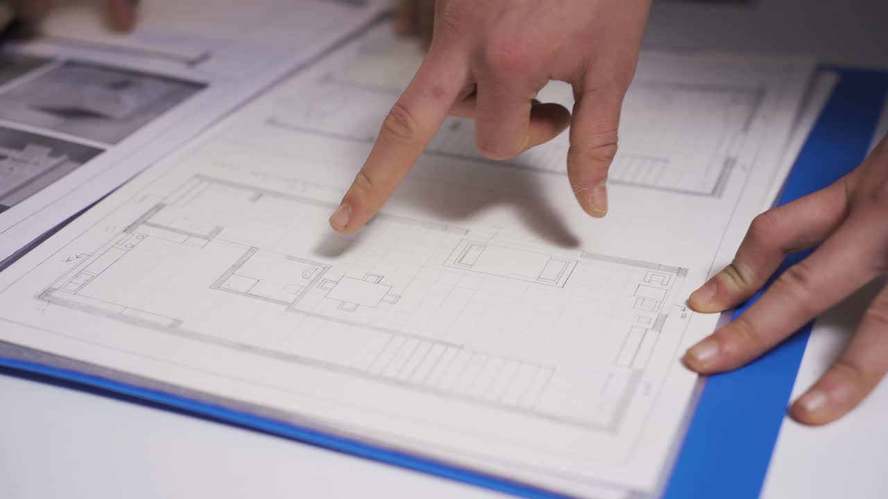 joven diseñador de interiores trabajando en su estudio. dibujos arquitectónicos.