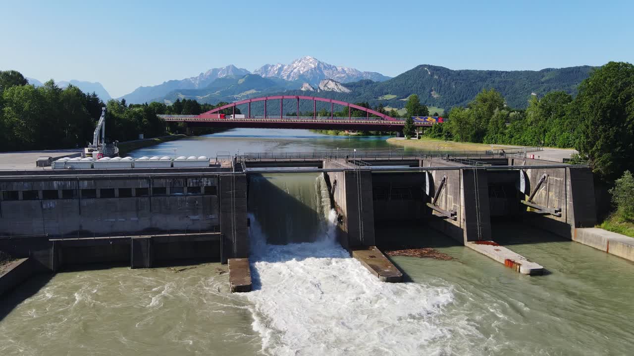 Aerial shot of cyclist riding over dam at Kraftwerk Urstein by Salzach River