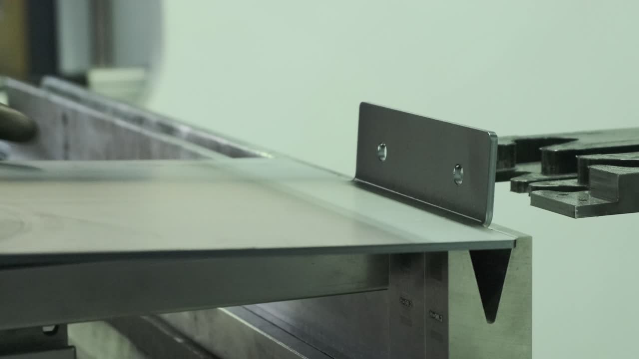 industry machine precise metal bending process, close up
