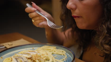 woman enjoying the taste of a gourmet spaghetti dinner at the restaurant
