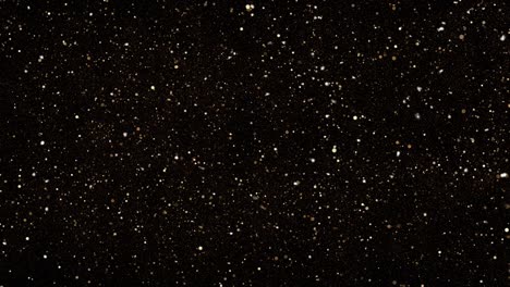 glittering gold particles. christmas, celebration, falling - abstract background