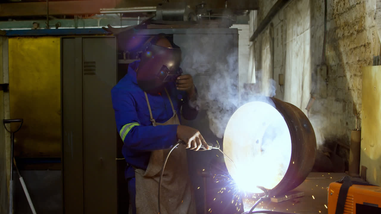 Metalsmith using welding torch in workshop 4k