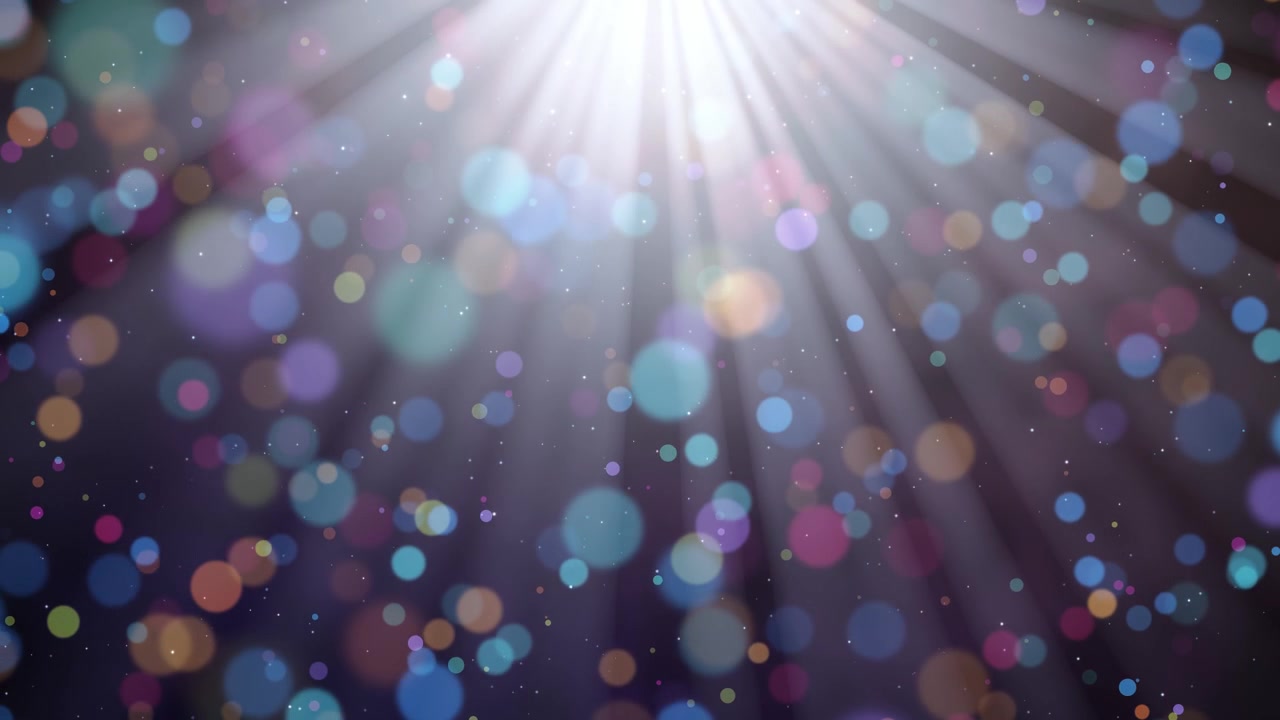 Vibrant colorful bokeh circles floating down on a dark background, illuminated by bright rays, creating a festive, loopable magical scene