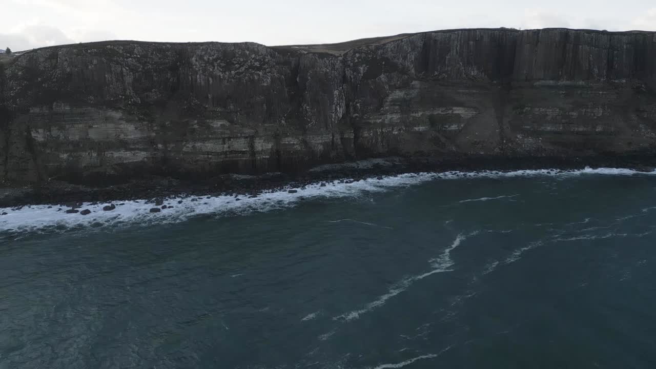 Kilt rock sea cliffs in skye, scotland, with waves crashing, aerial view
