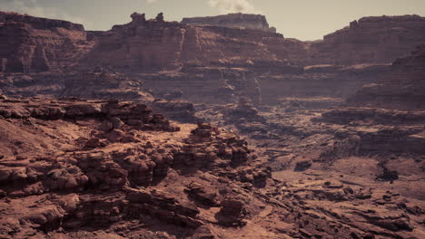 vast arid landscape with rugged rock formations during golden hour