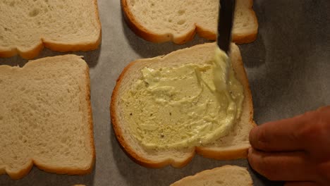 spreading mayonnaise sauce on homemade student style sandwiches