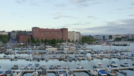 slow aerial pan of boats in a dock along the waterfront of helsinki, finland