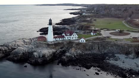 orbit aerial around portland head lighthouse during winter time in maine