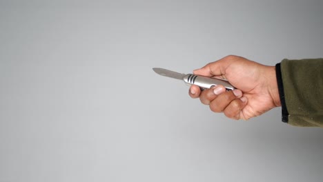 hand holding and manipulating a multi-tool knife
