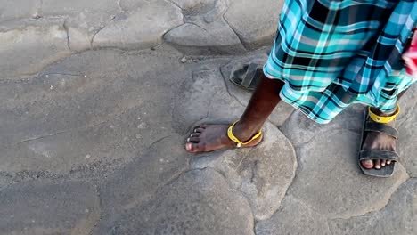 Close-up-of-Engaresero-footprints-with-Masai-tribe-feet-over,-oldest-humantracks