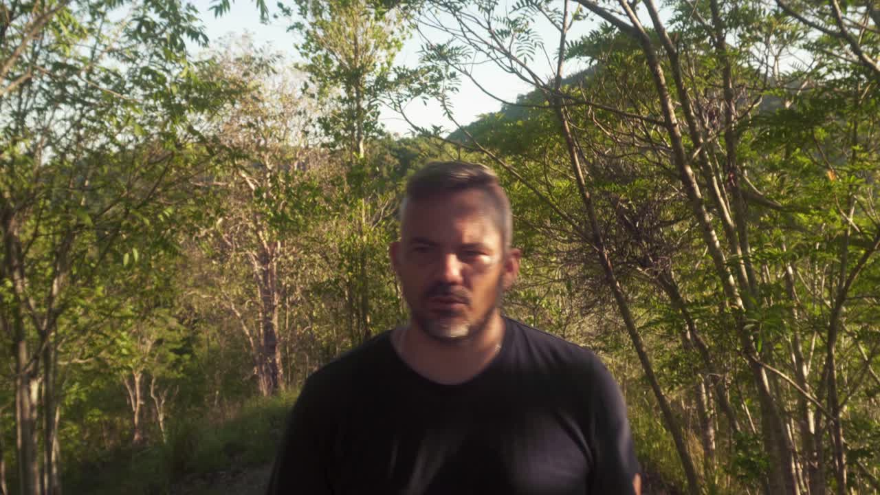 man walking nature walk towards camera in cairns.
