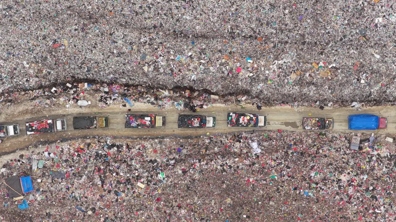 Camion della spazzatura in coda presso una gigantesca discarica a Bali