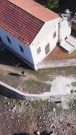 aerial view of an old church with ruins and tombs