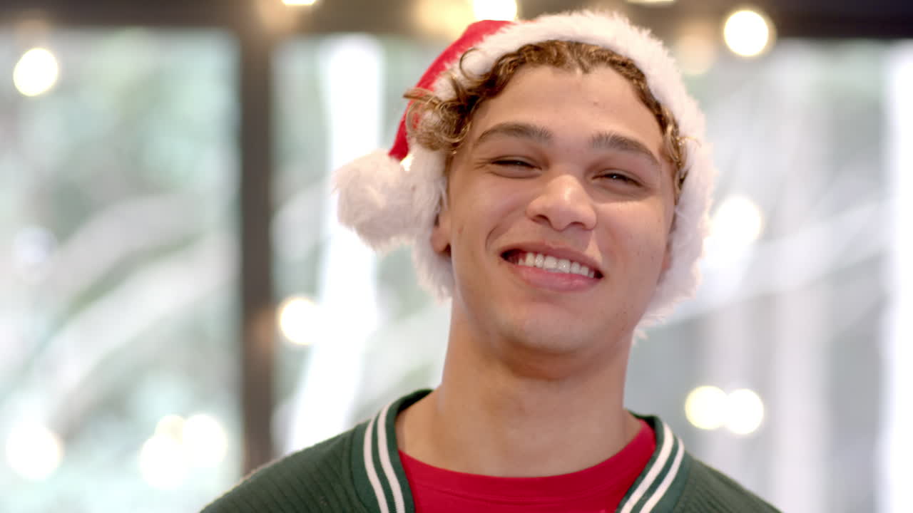 Smiling man wearing Santa hat enjoying festive holiday season at home