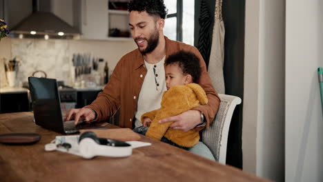 father working from home with baby