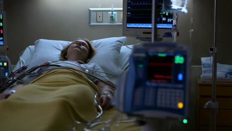 patient in hospital bed with monitoring equipment