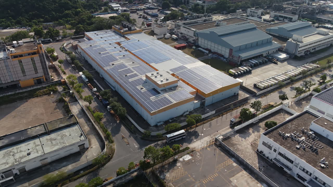 Solar panels covering roof of innovative factory, Hong Kong; drone