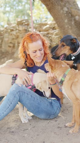 woman bonding with her dogs outdoors