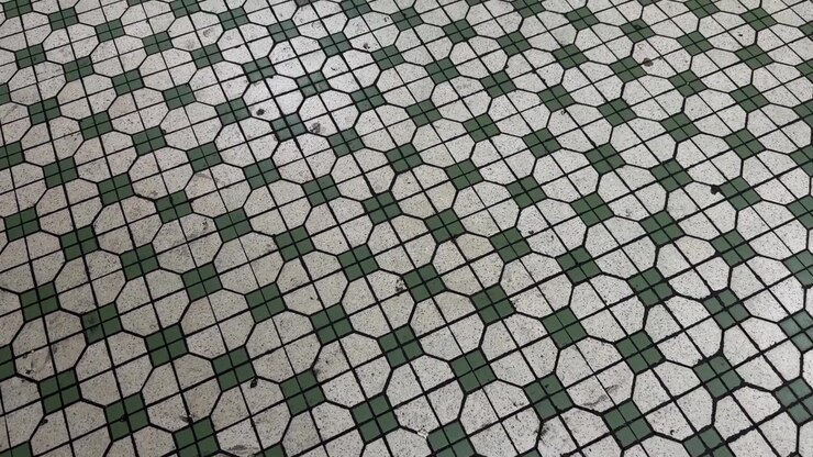 Wide establishing top-down view of vintage mosaic tiles flooring composed of simple, repeating geometric patterns inside a traditional Singapore Kopitiam (coffee shop).