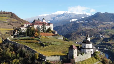 Aerial-Drone-Over-a-medieval-Castle-in-the-middle-of-the-Vineyards-in-Italy-named-Salita-Sabiona