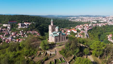 close drone orbit around the historic church at tsaravets fortress, highlighting medieval bulgarian architecture and stone craftsmanship.