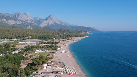 Aerial-drone-shot-of-the-ocean,-beach-and-mountain-coast-in-Antalya,-Kemer,-Turkey