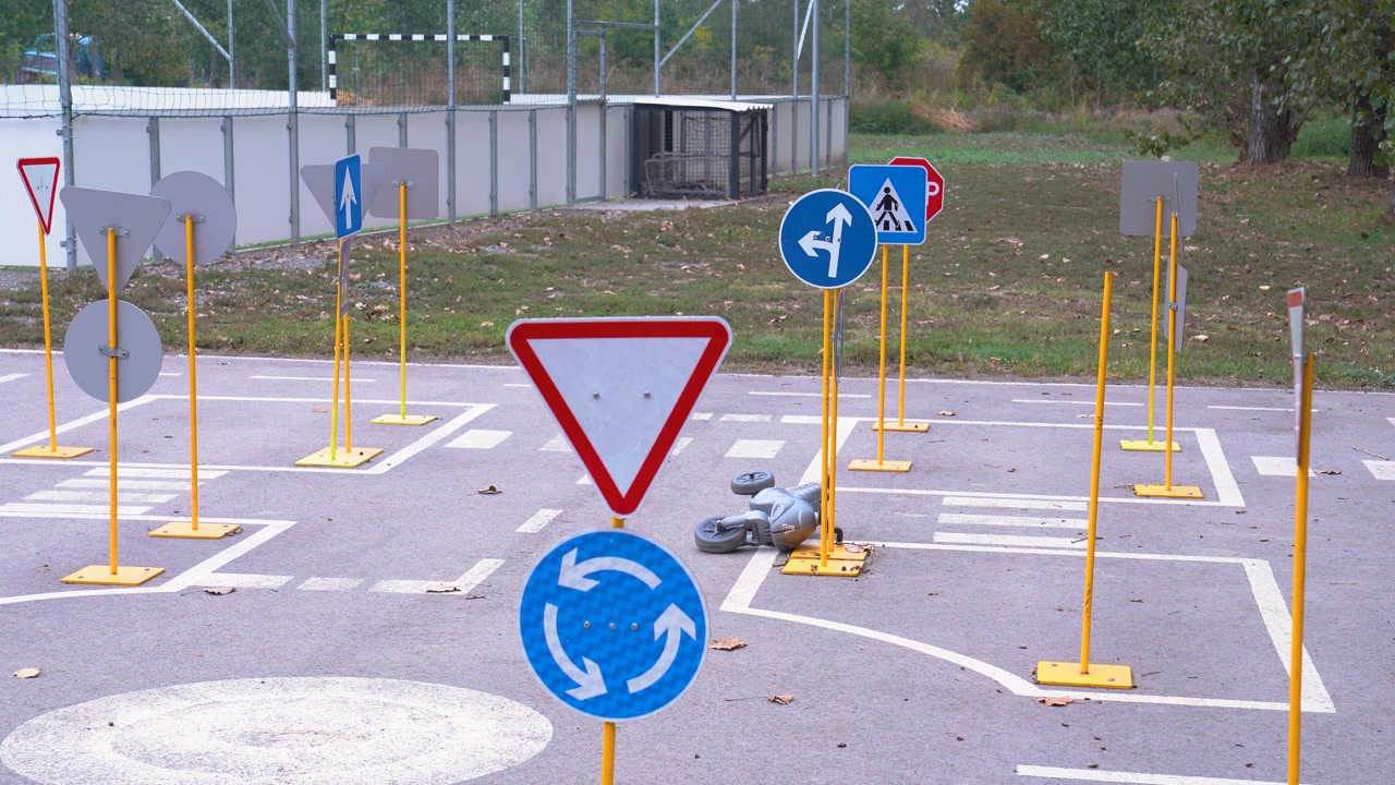 Children's driving course with miniature traffic signs for teaching road safety