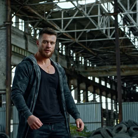 man posing in ruined building