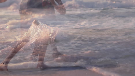 animation of bottle on beach over couple at beach splashing in sea