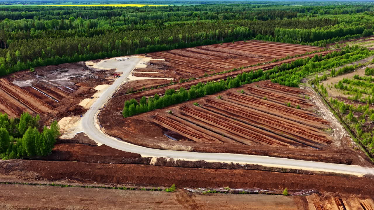 Wind turbine foundation under construction with exposed concrete base in peat field