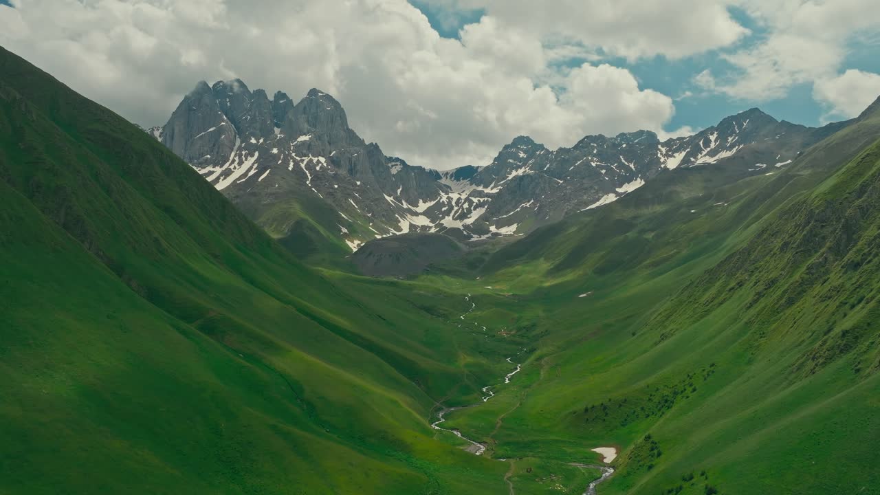 Lush green valley in Georgia's Juta village under a vast sky