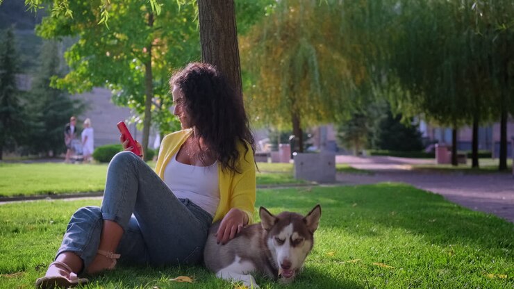 Woman relaxing in a park with her dog