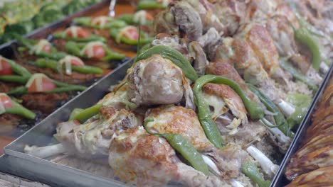 tray of roasted chicken drumsticks and rice with green peppers