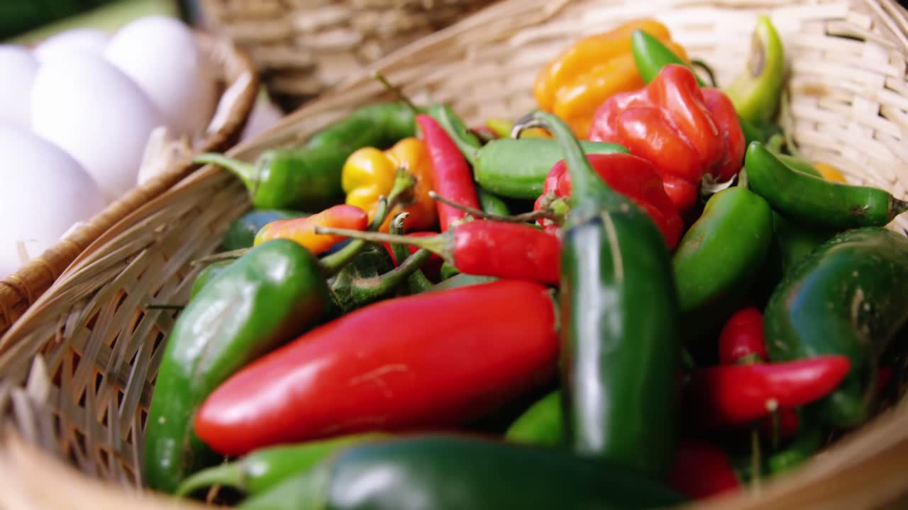 Capsicum vegetables and eggs in a wicker basket