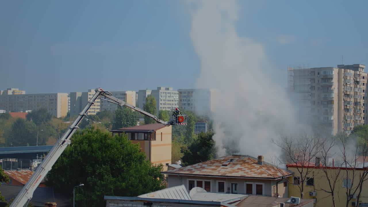 House burning in city neighbourhood and firefighters helping