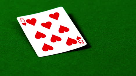 eight of hearts falling on casino table