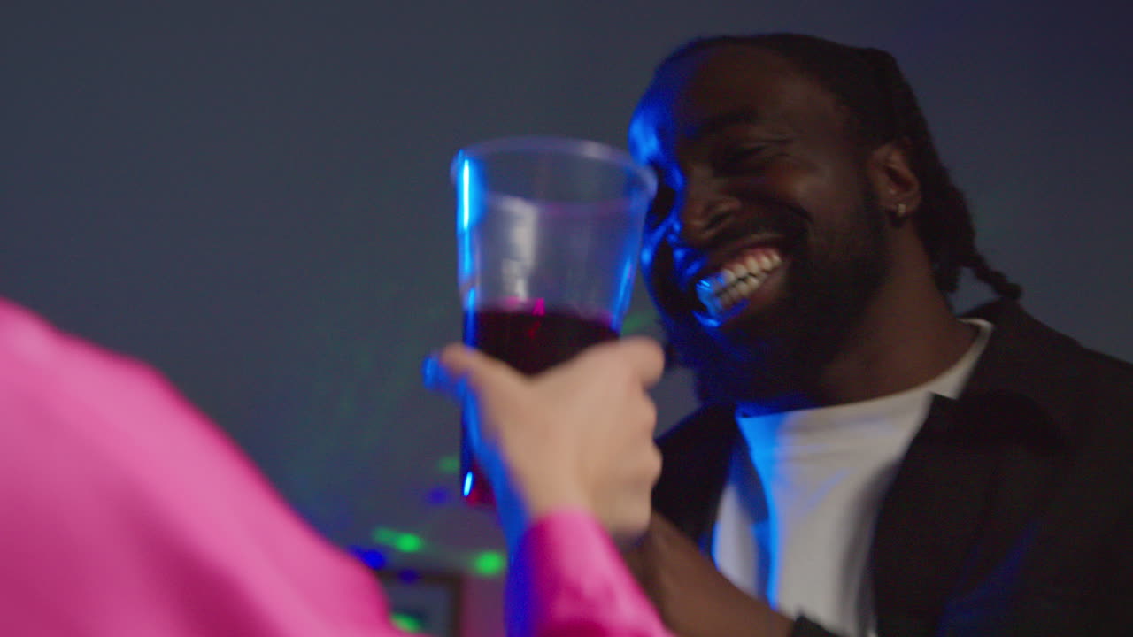 Young Couple Having Fun Dancing And Drinking Alcohol At House Party Together 5